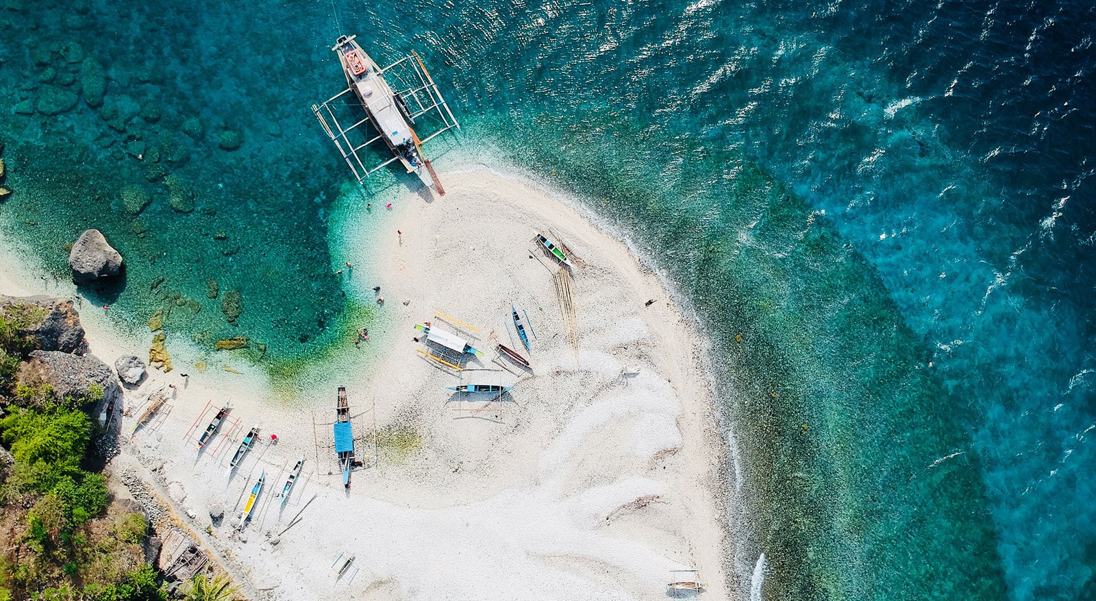 small boats and white sandy beach in Puerto Galera